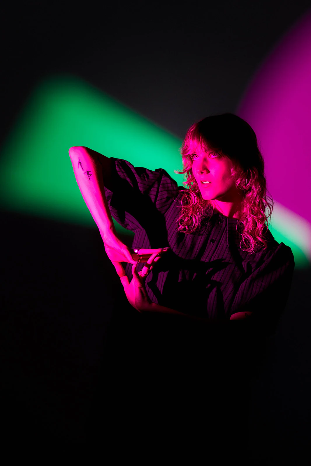 Olivia Carter under green and magenta light